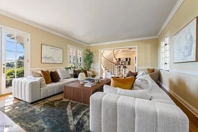 a living room with furniture and a chandelier