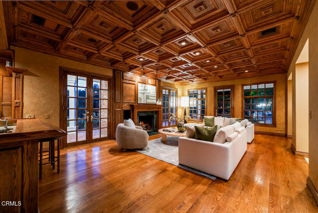 427 Long Canyon Road Bradbury, CA 91008 - Photo 51 of 62 a living room with fireplace furniture and a wooden floor