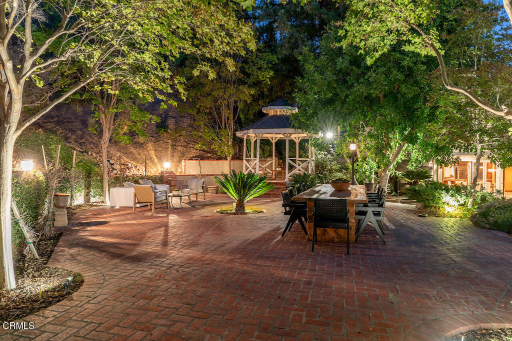 427 Long Canyon Road Bradbury, CA 91008 - Photo 52 of 62 a view of a patio with table and chairs and potted plants
