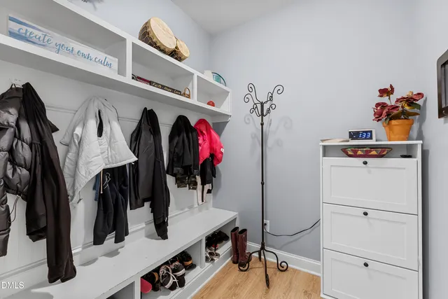 a kitchen with stainless steel appliances granite countertop a stove top oven a sink dishwasher a dining table and chairs with wooden floor