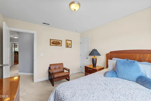 a bedroom with a bed and flat screen tv