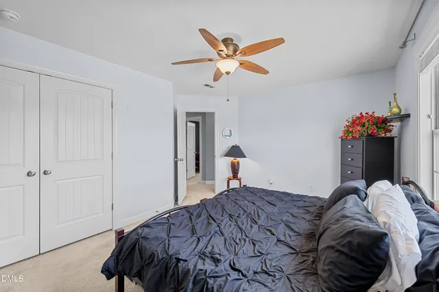 a bathroom with a granite countertop sink a toilet and a mirror