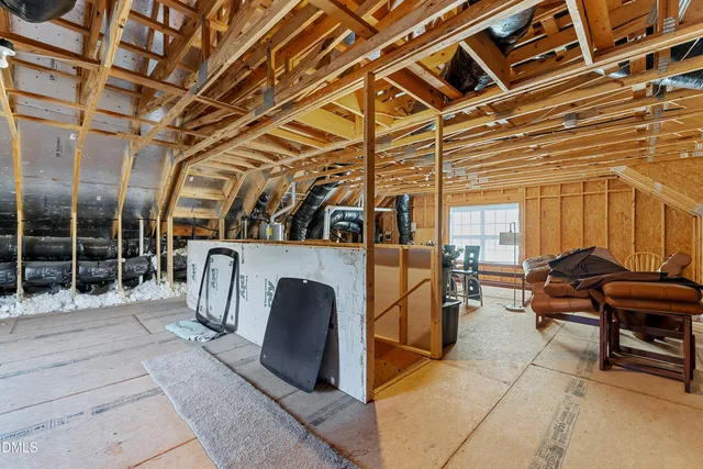 a living room with furniture and floor to ceiling windows
