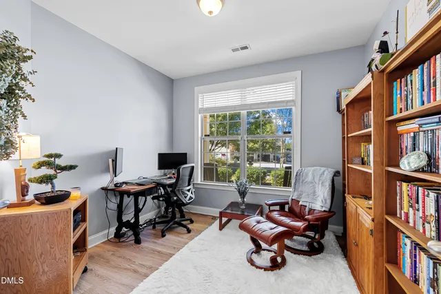 a living room with furniture bookshelf and a window