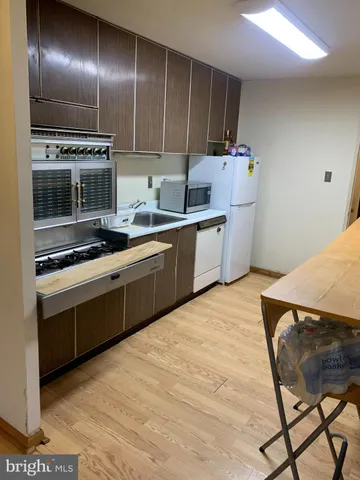 a kitchen with a sink cabinets and stainless steel appliances