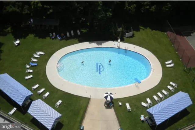 a view of a swimming pool with seating area