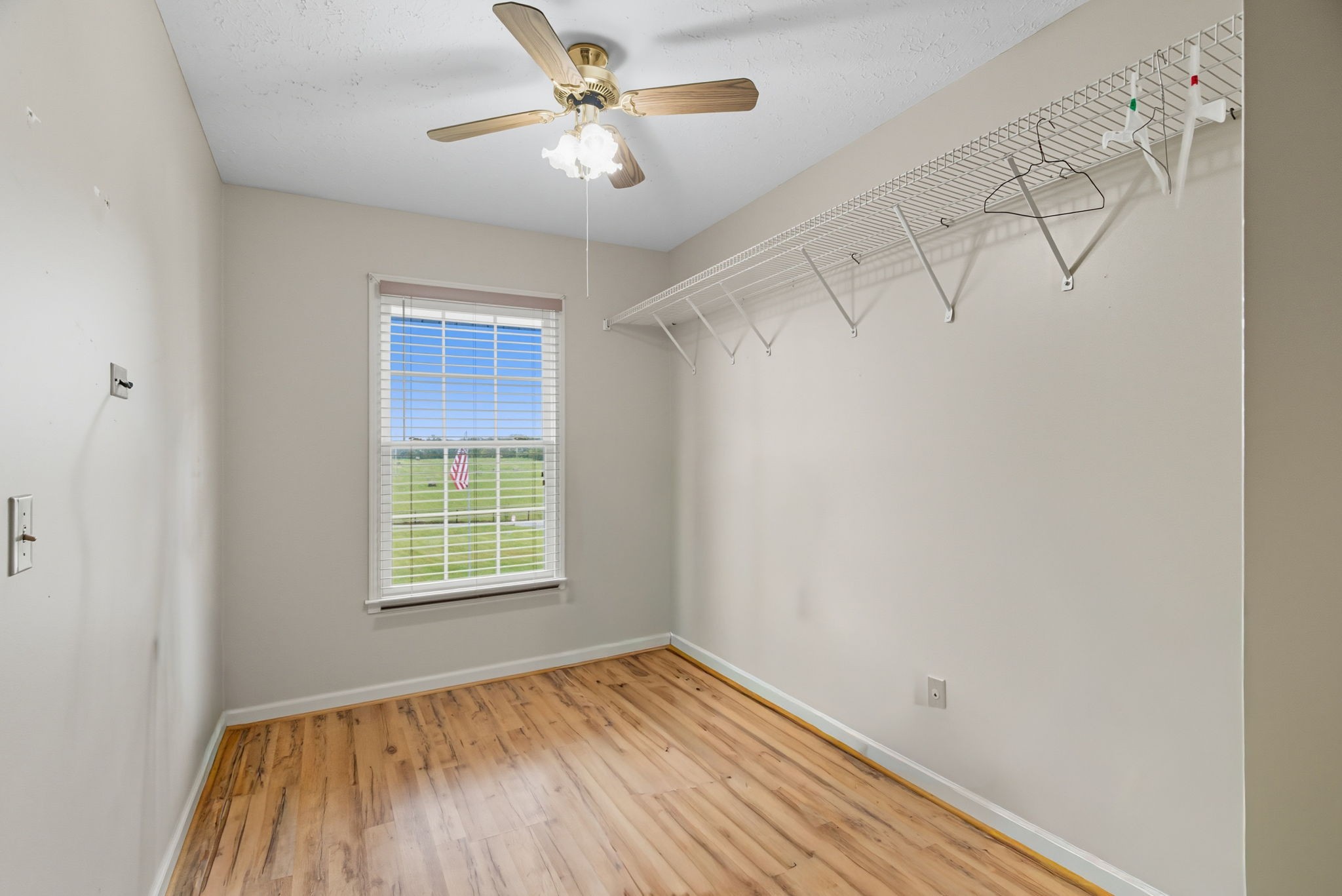 1021 Maple Grove Road Lafayette, TN 37083 - Photo 14 of 49 a view of empty room with wooden floor and fan