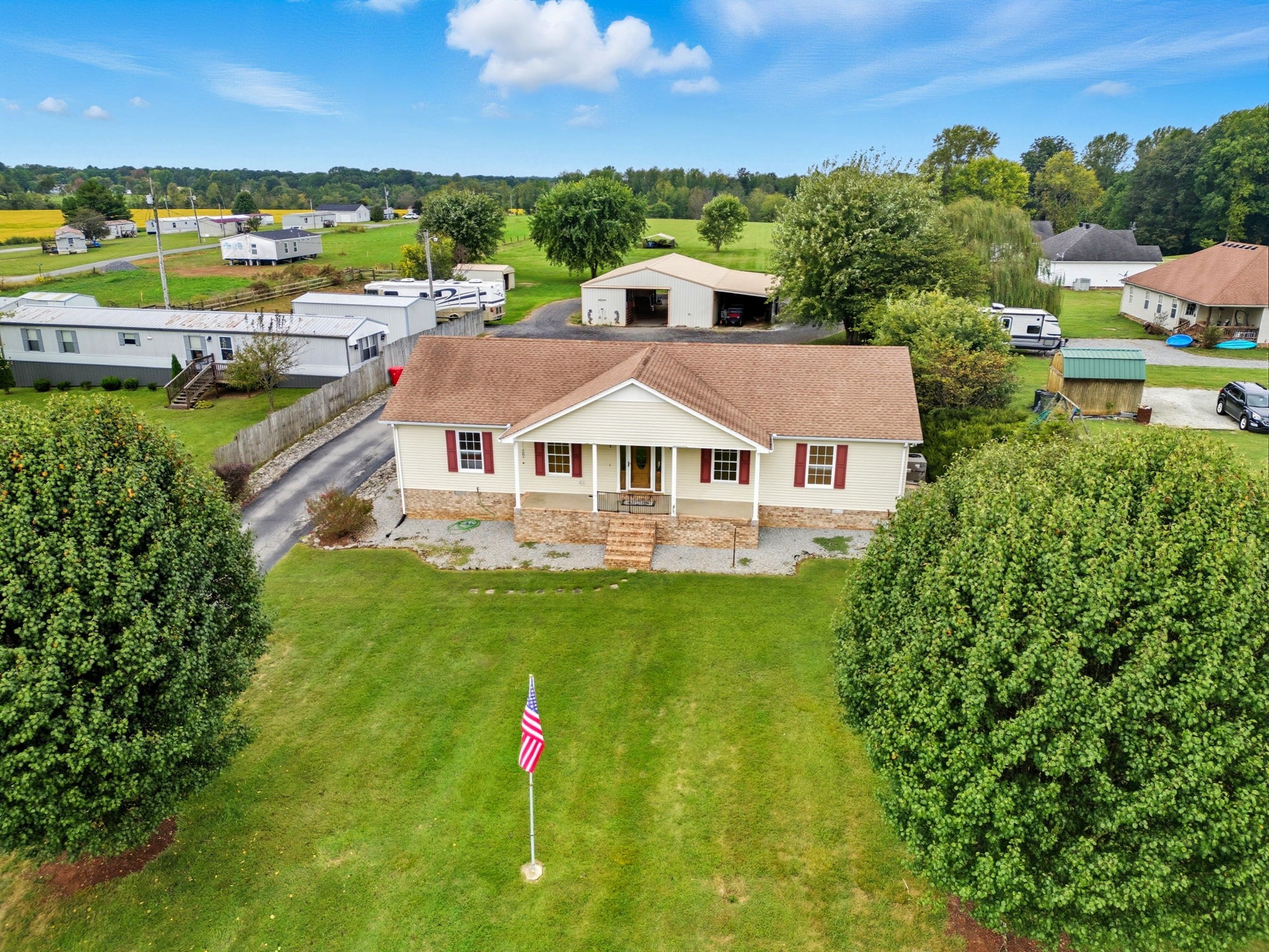 1021 Maple Grove Road Lafayette, TN 37083 - Photo 28 of 49 a aerial view of a house with big yard and large trees