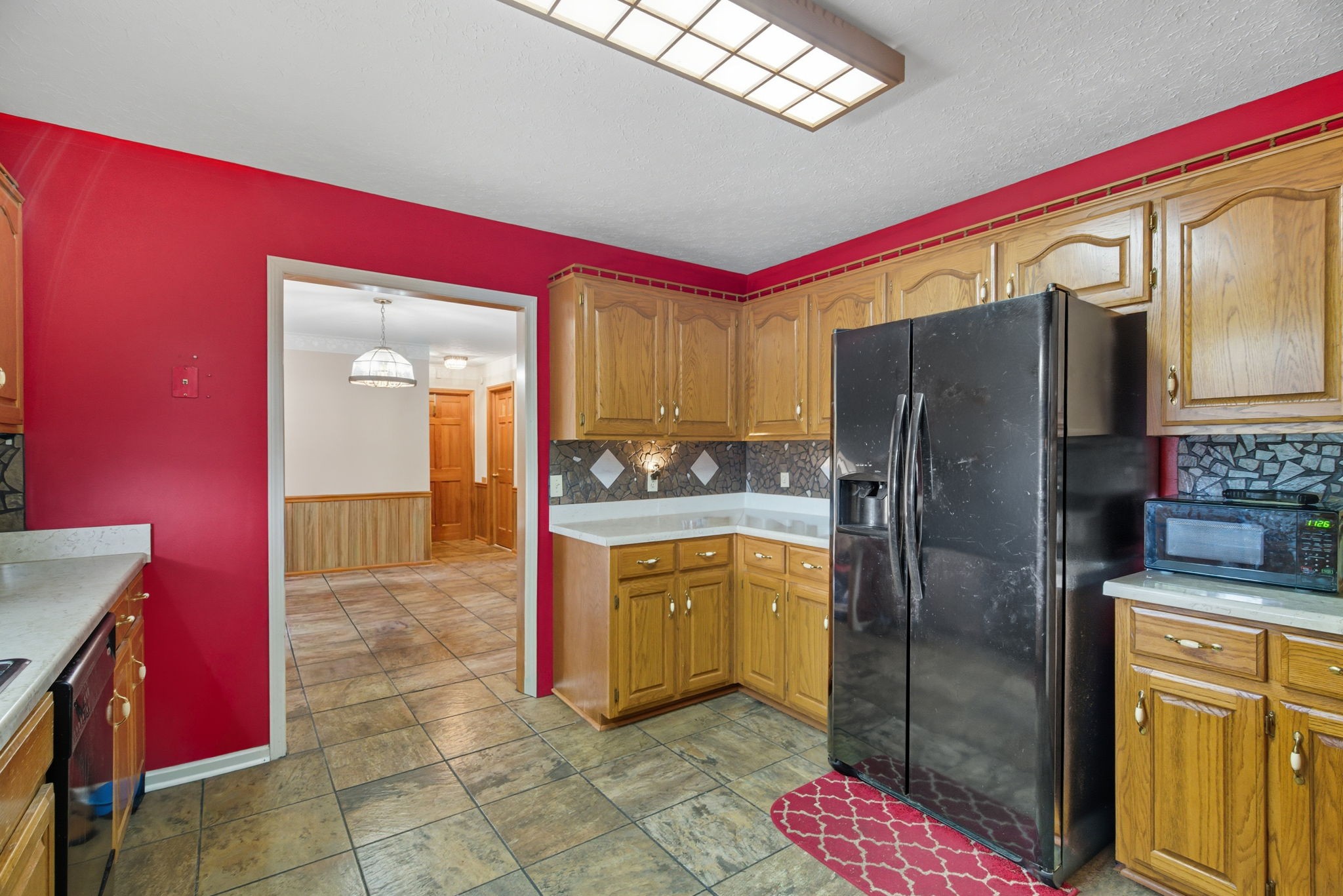 1021 Maple Grove Road Lafayette, TN 37083 - Photo 8 of 49 a kitchen with stainless steel appliances granite countertop a refrigerator a stove and a sink