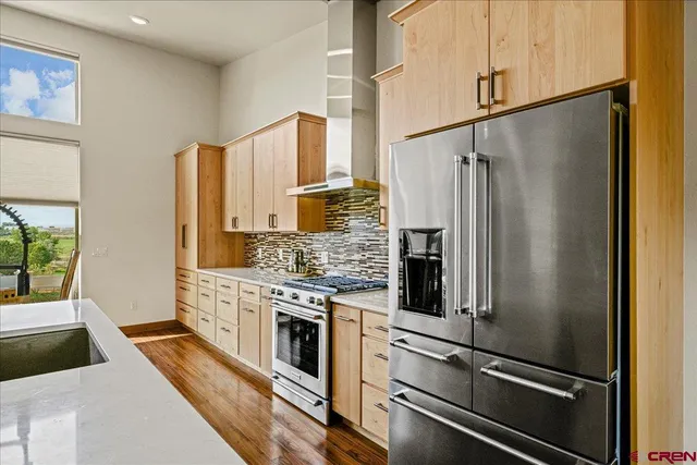 a kitchen with stainless steel appliances a refrigerator sink and stove