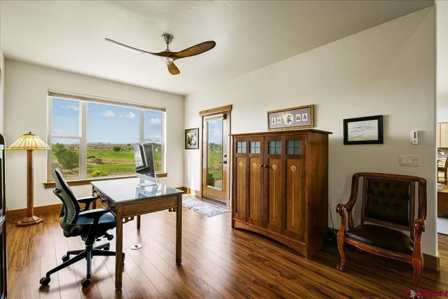 a workspace with wooden floor windows a fireplace and a window