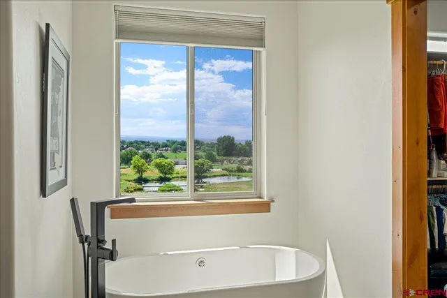 a bathroom with a bathtub and window