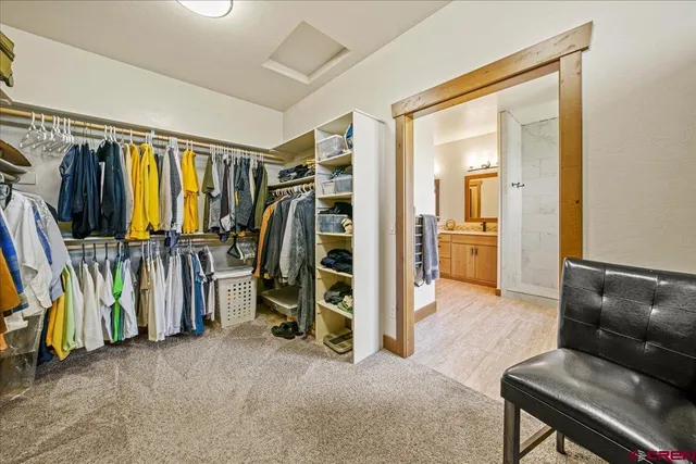 a view of walk in closet with clothes