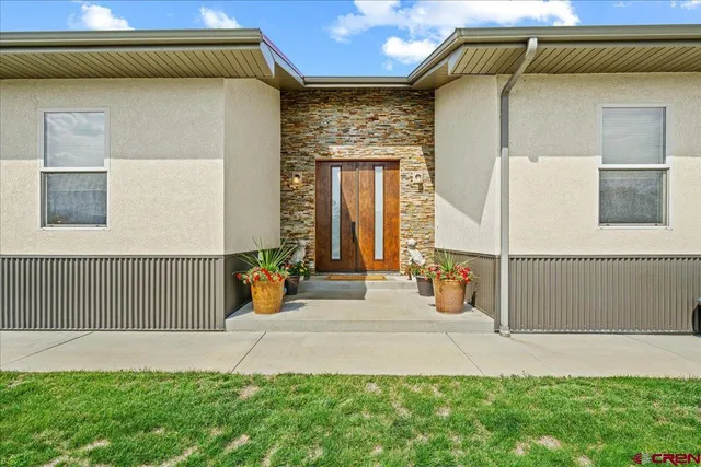 a front view of a house with garden
