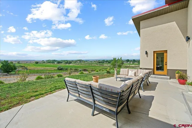 a view of a patio with dining table and chairs