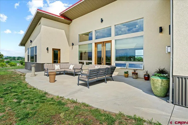 a building outdoor space with patio furniture and potted plants