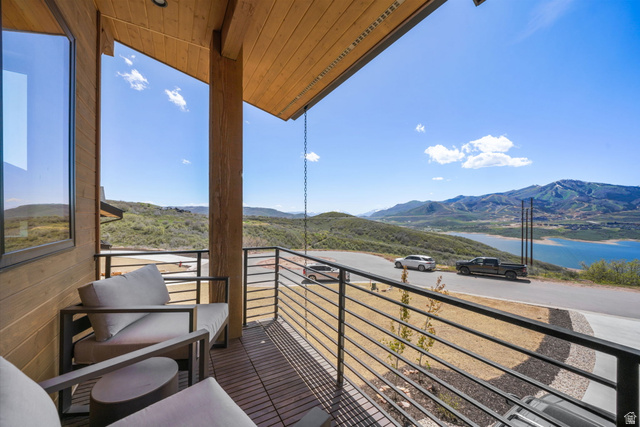 10646 North Reflection Ridge Hideout, UT 84036 - Photo 30 of 43 Covered balcony featuring a wood-finish ceiling, horizontal railing system, and a scenic mountain and lake backdrop