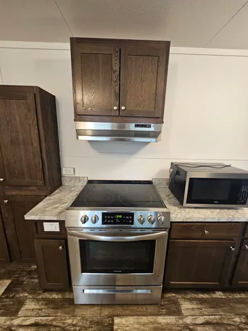 a stove top oven sitting inside of a kitchen