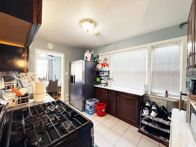 a kitchen with stainless steel appliances granite countertop a stove and a refrigerator