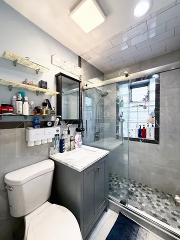 a bathroom with a toilet sink and mirror