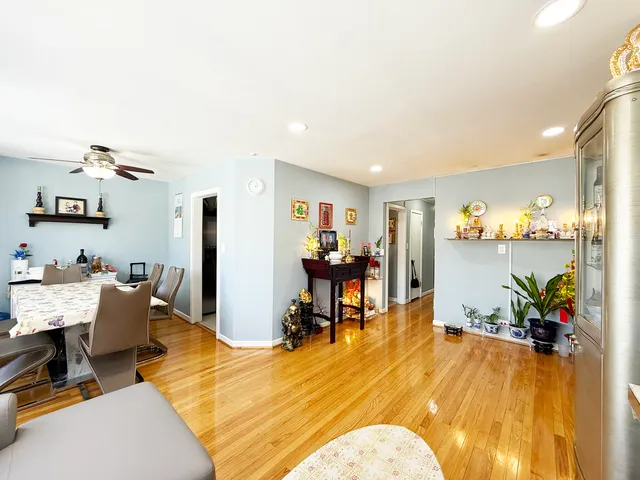 a living room with dining room and wooden floor