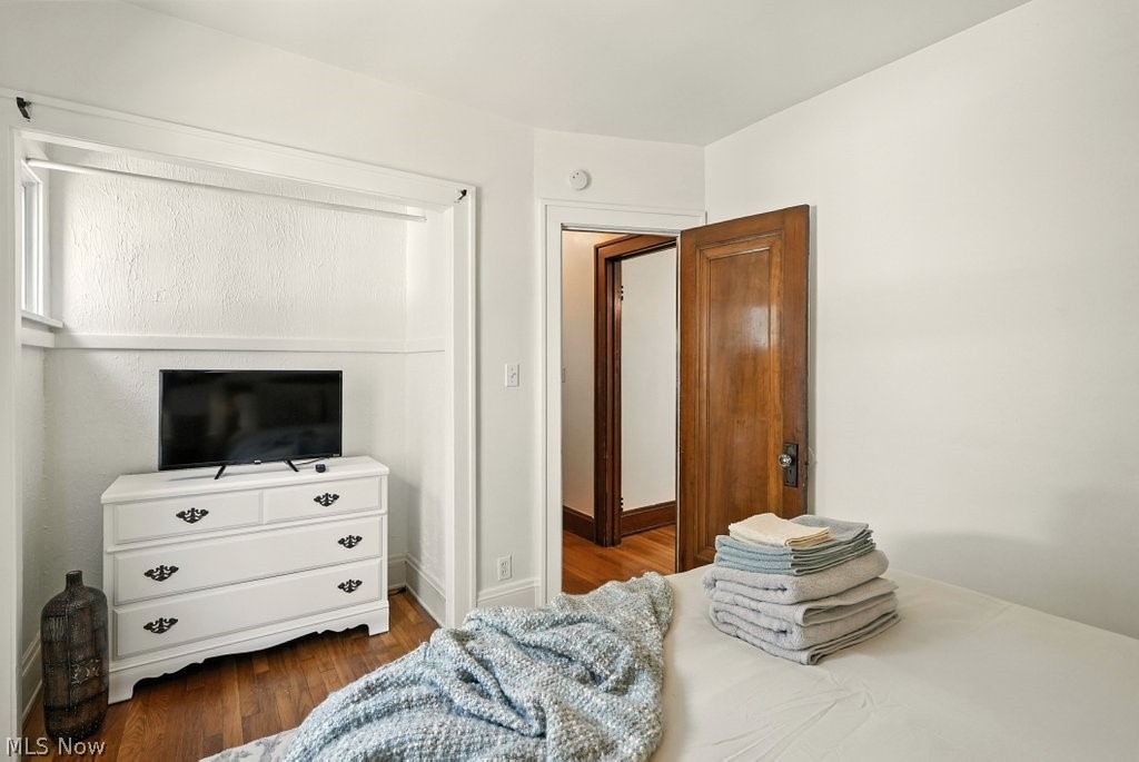 3579 Bosworth Road Cleveland, OH 44111 - Photo 38 of 39 Hardwood flooring, painted white walls, and a solid wood interior door with trim