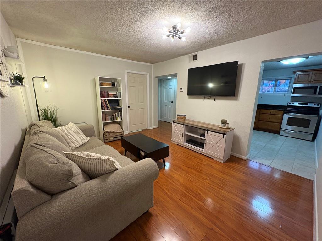 250 Little Street, Unit C101 Athens, GA 30605 - Photo 2 of 16 a living room with furniture and a flat screen tv