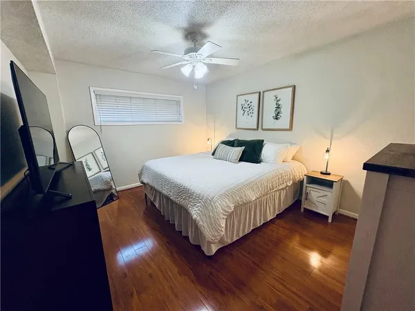 a bedroom with a bed and wooden floor