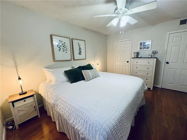 a bedroom with bed and wooden floor