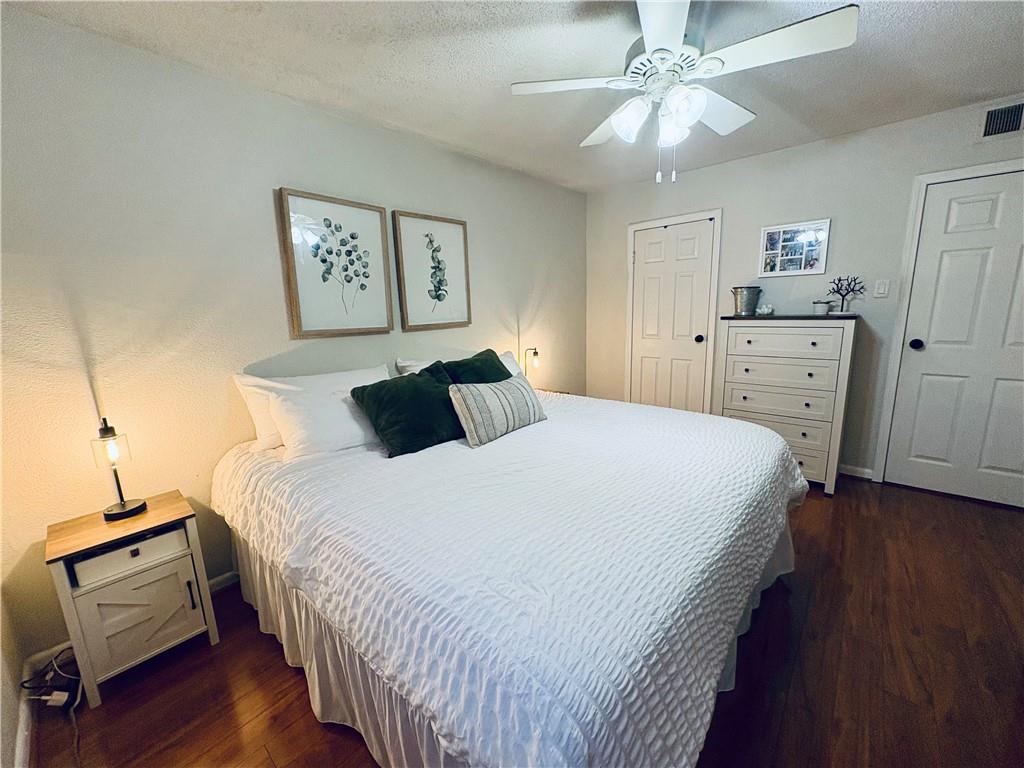 250 Little Street, Unit C101 Athens, GA 30605 - Photo 6 of 16 a bedroom with bed and wooden floor