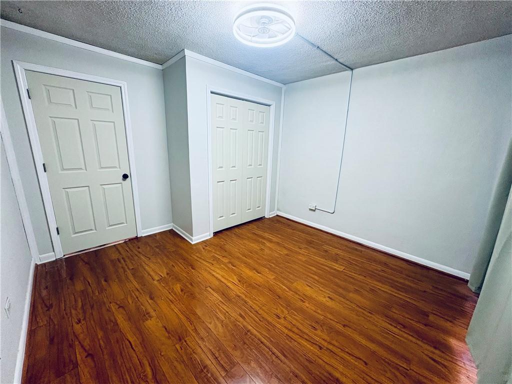 250 Little Street, Unit C101 Athens, GA 30605 - Photo 8 of 16 a view of empty room with wooden floor and fan