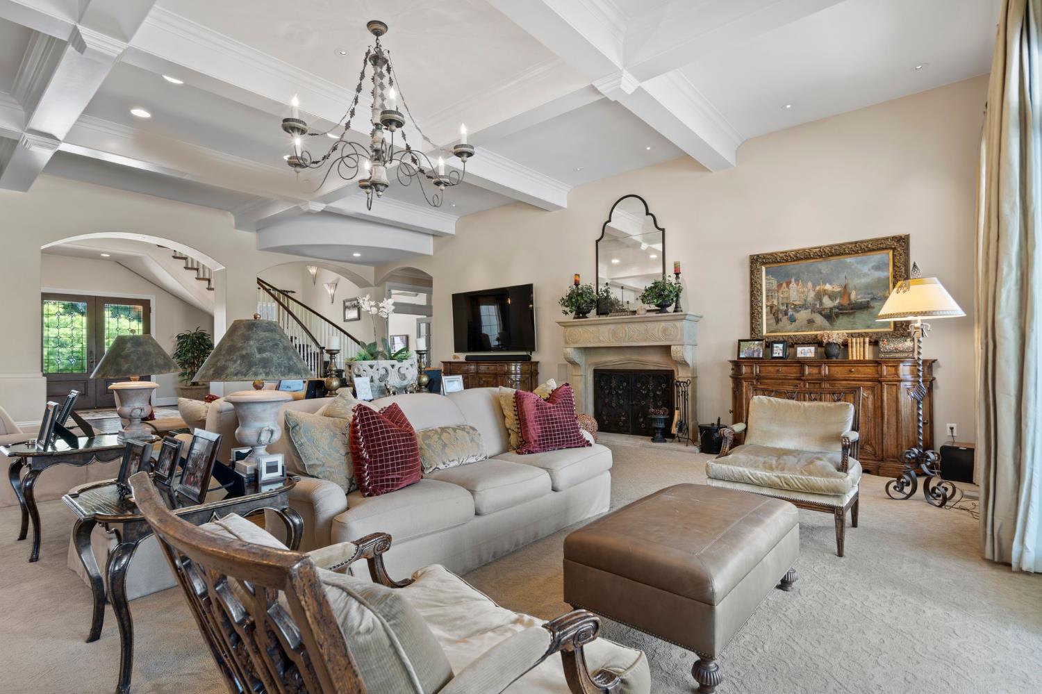 10676 Wilton Road Elk Grove, CA 95624 - Photo 12 of 71 a living room with furniture a fireplace and a chandelier