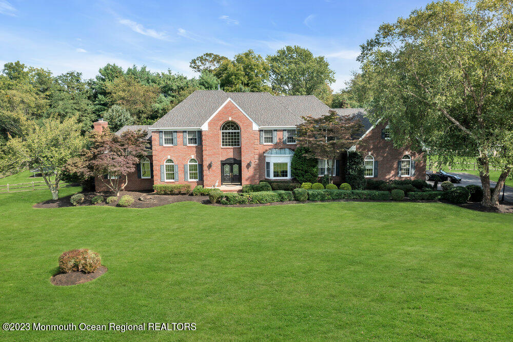 3 Goose Point Drive Colts Neck, NJ 07722 - Photo 2 of 66 a front view of a house with a yard and trees