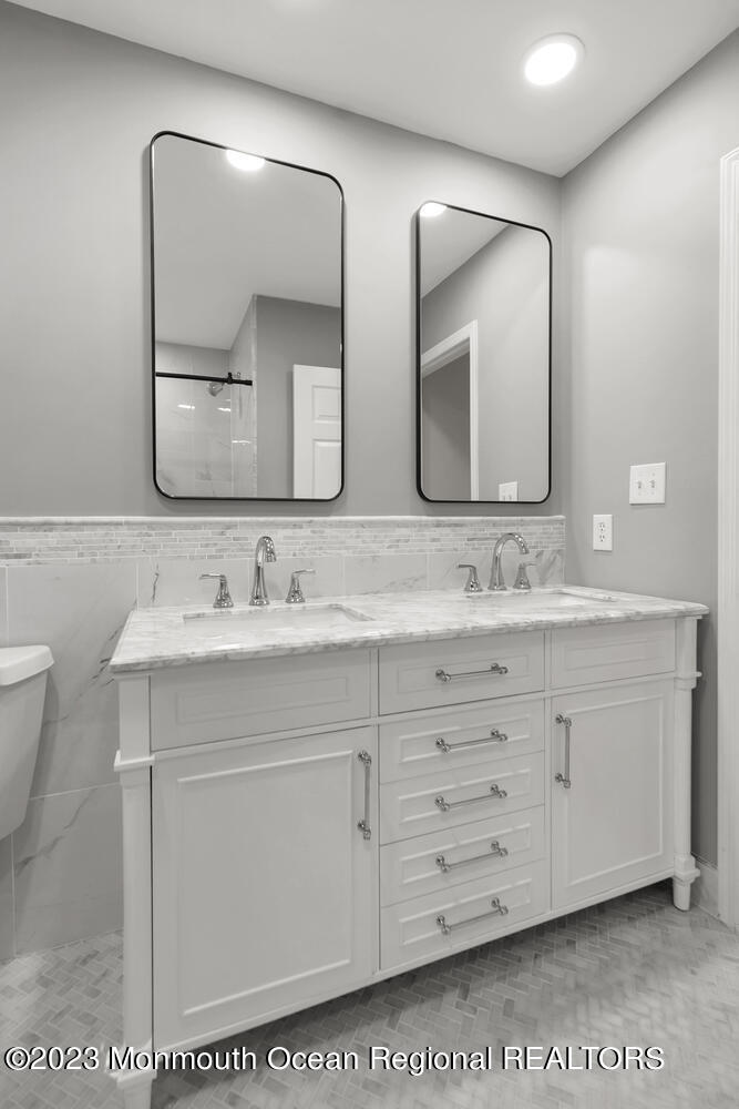 3 Goose Point Drive Colts Neck, NJ 07722 - Photo 32 of 66 a bathroom with a double vanity sink and mirror