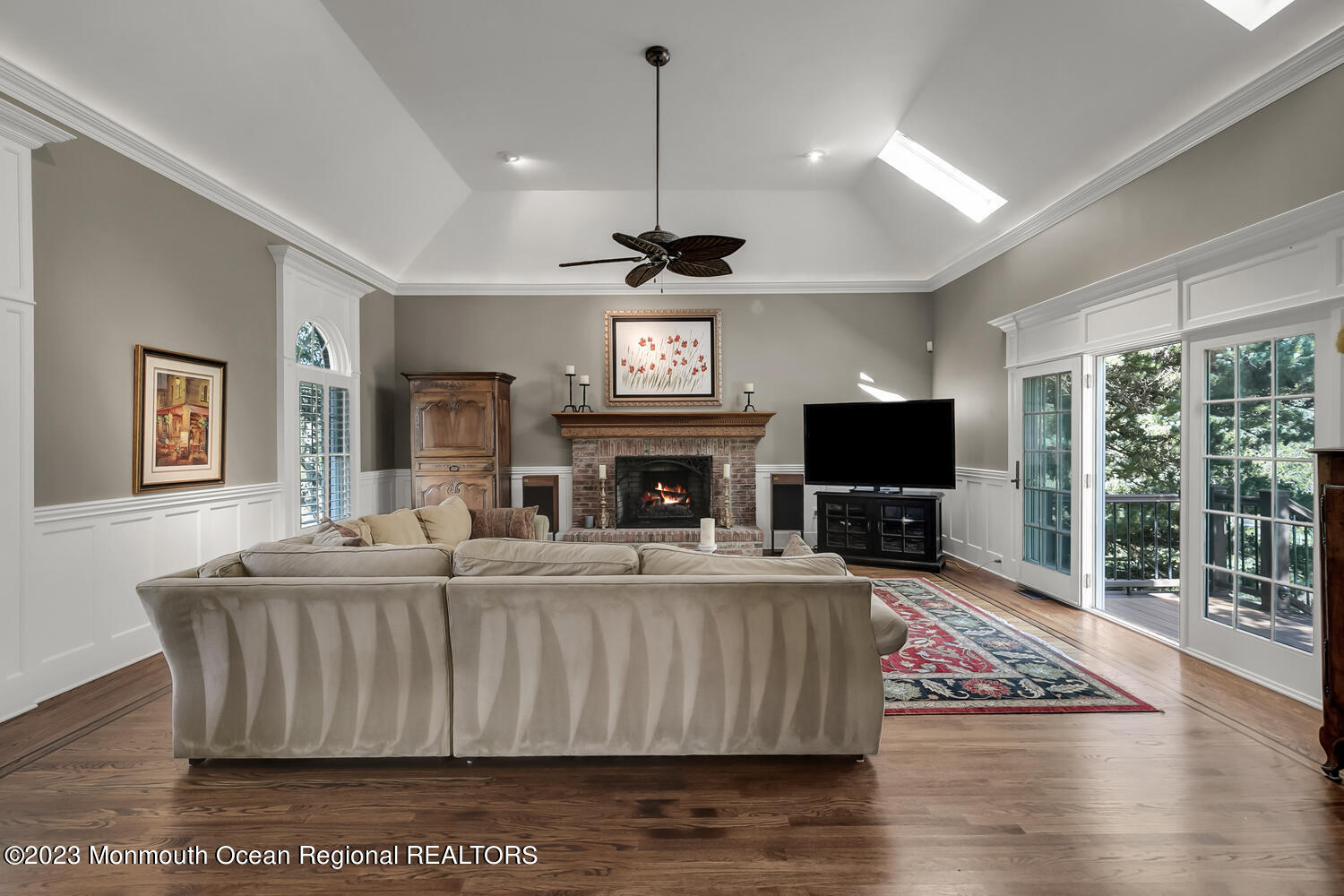 3 Goose Point Drive Colts Neck, NJ 07722 - Photo 8 of 66 a living room with furniture a flat screen tv and a fireplace