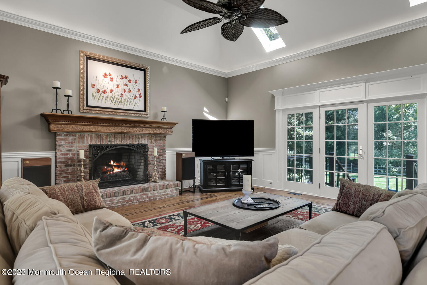 3 Goose Point Drive Colts Neck, NJ 07722 - Photo 10 of 66 a living room with furniture a flat screen tv and a fireplace