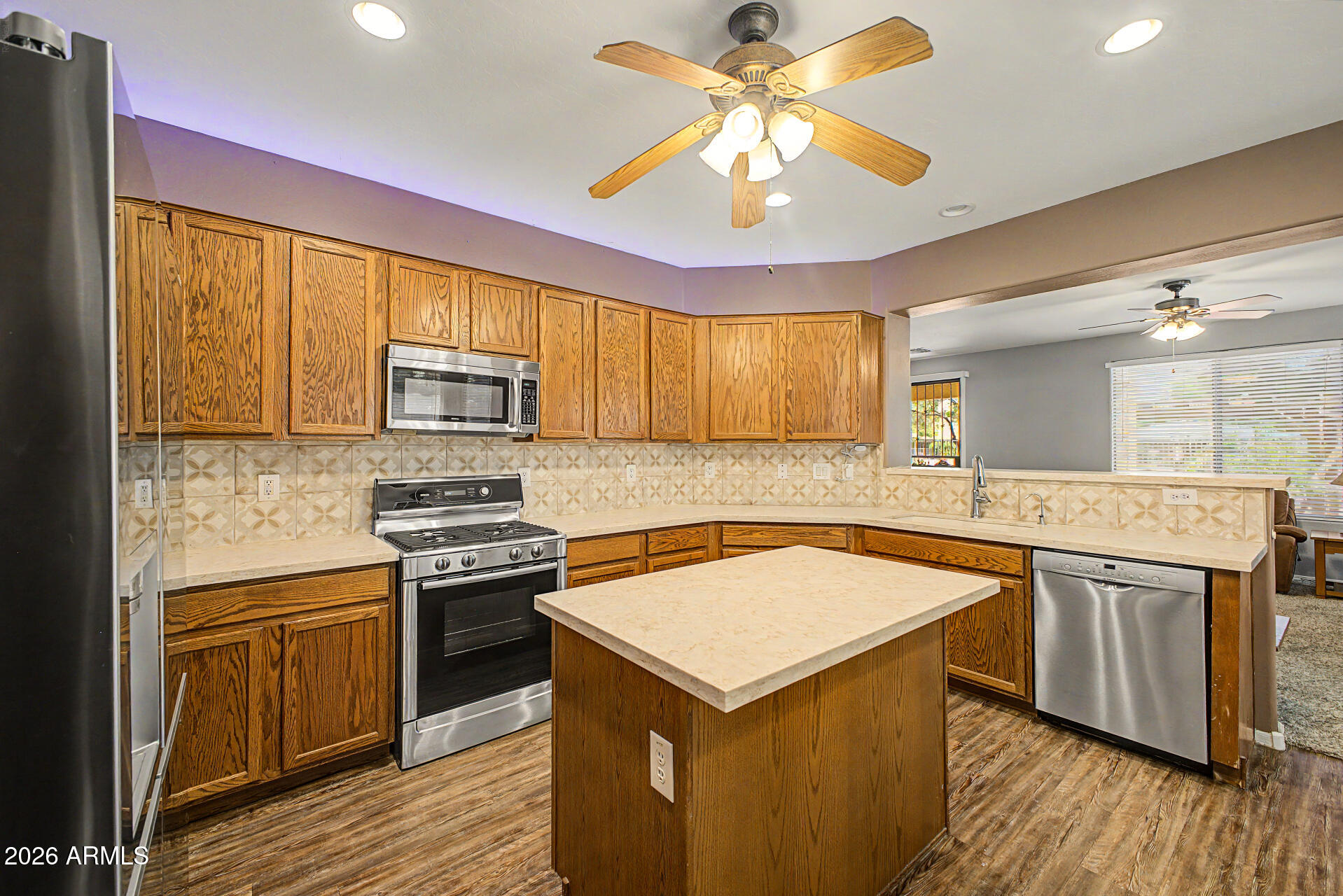 6622 West Harwell Road Laveen, AZ 85339 - Photo 11 of 32 a kitchen with stainless steel appliances a stove sink and microwave