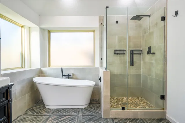 a bathroom with a bathtub and shower