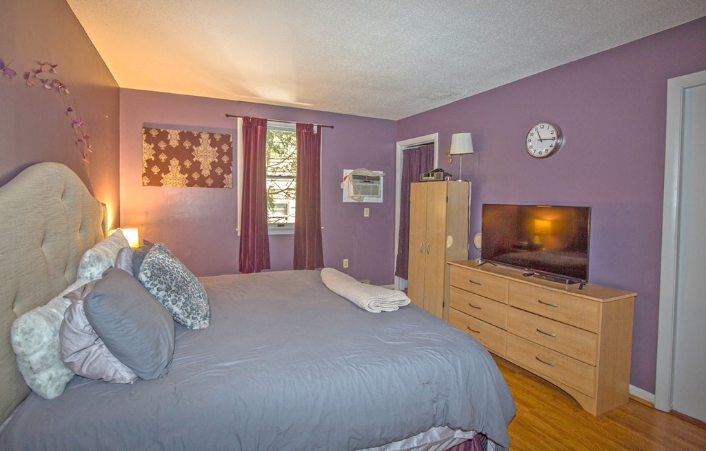 173 Cottage Road Enfield, CT 06082 - Photo 31 of 41 a bedroom with a bed and flat screen tv