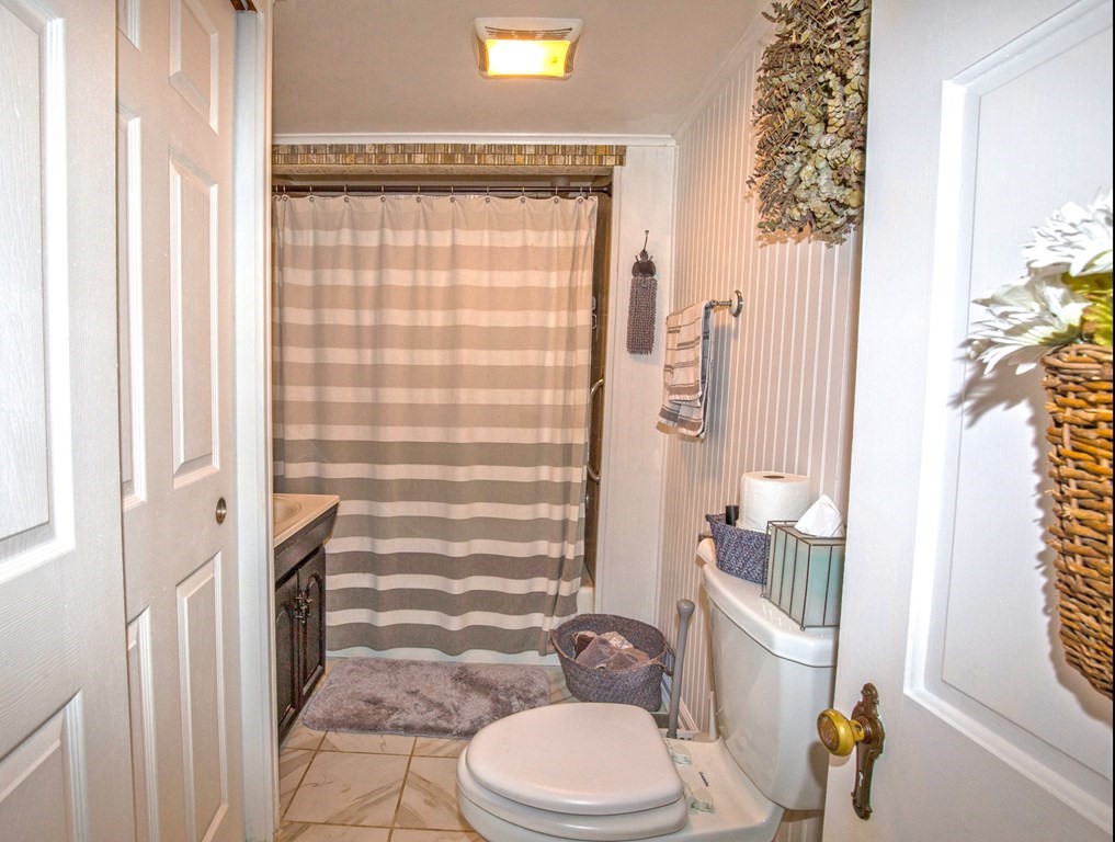 173 Cottage Road Enfield, CT 06082 - Photo 36 of 41 a bathroom with a toilet and shower curtain