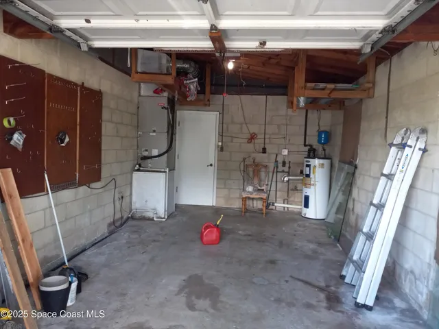 an empty room with a window and a ceiling fan