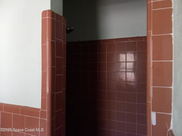 a bathroom with a shower and a glass door