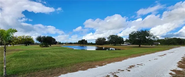 a bathroom with a granite countertop toilet and a sink