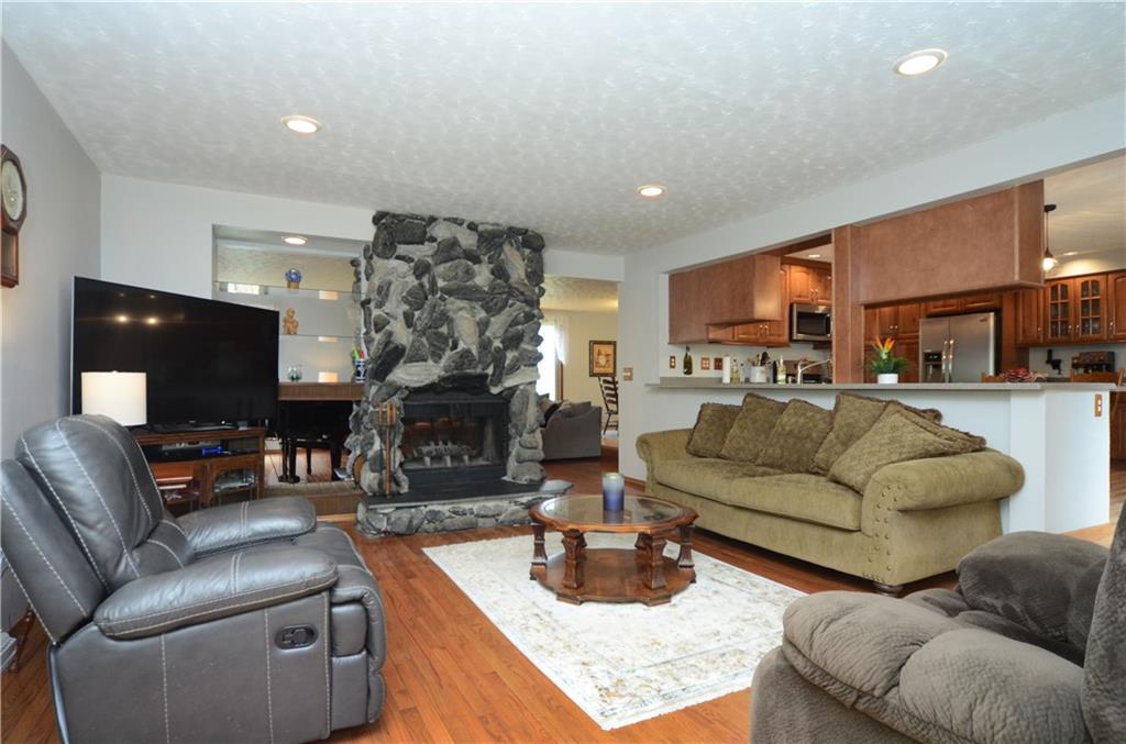 5639 Aiken Road McKees Rocks, PA 15136 - Photo 11 of 23 The family room offers hardwood floors and a shared stone gas fireplace.