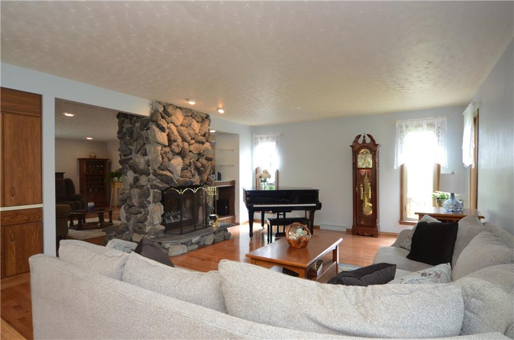 5639 Aiken Road McKees Rocks, PA 15136 - Photo 5 of 23 The sunken living room includes hardwood floors and a stone log burning shared fireplace.