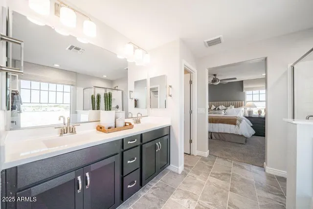 a en suite bathroom with double sink and a mirror