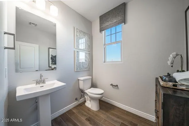 a bathroom with a sink toilet and a mirror