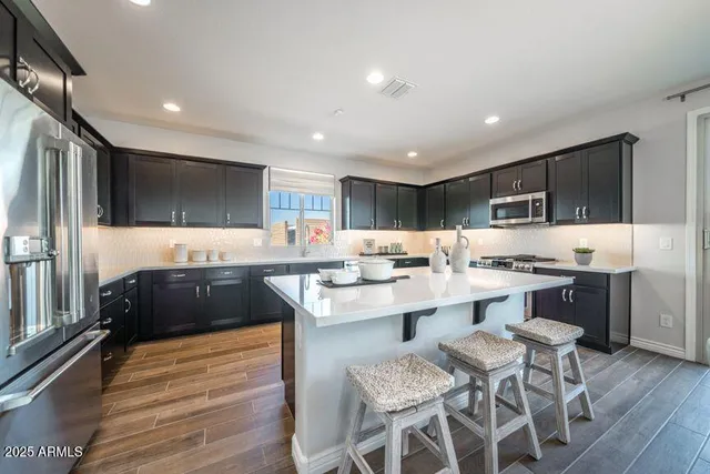 a large kitchen with lots of counter space and stainless steel appliances