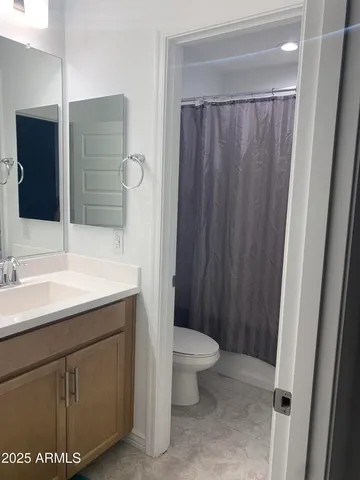 a bedroom with a bed and cabinet