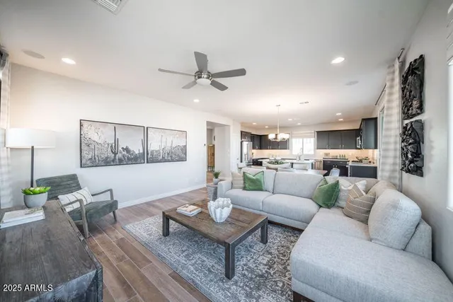 a living room with furniture kitchen view and a table